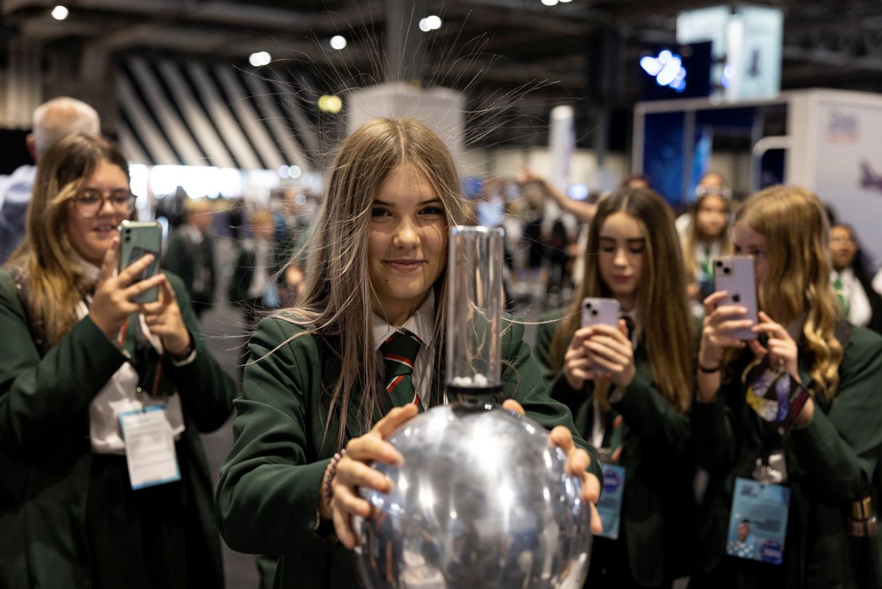 Young person discovers static energy with Van De Graaf Generator at The Big Bang Fair 