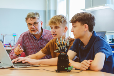 Secondary school students doing robotics experiment