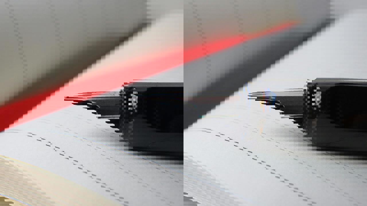 Notebook open with a pen laying on top