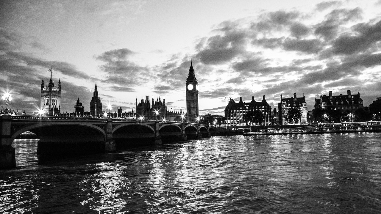Black and white image of the Palace of Westminster taken from the river Thames