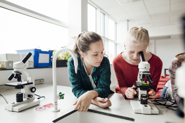 Secondary students using microscope