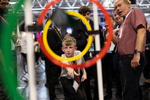 A young person interacts with exhibits and stands and activities at The Big Bang Fair