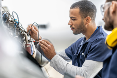 Two engineers work with cables