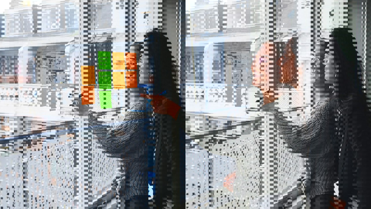 Business professionals sharing ideas and collaborating using Post it notes