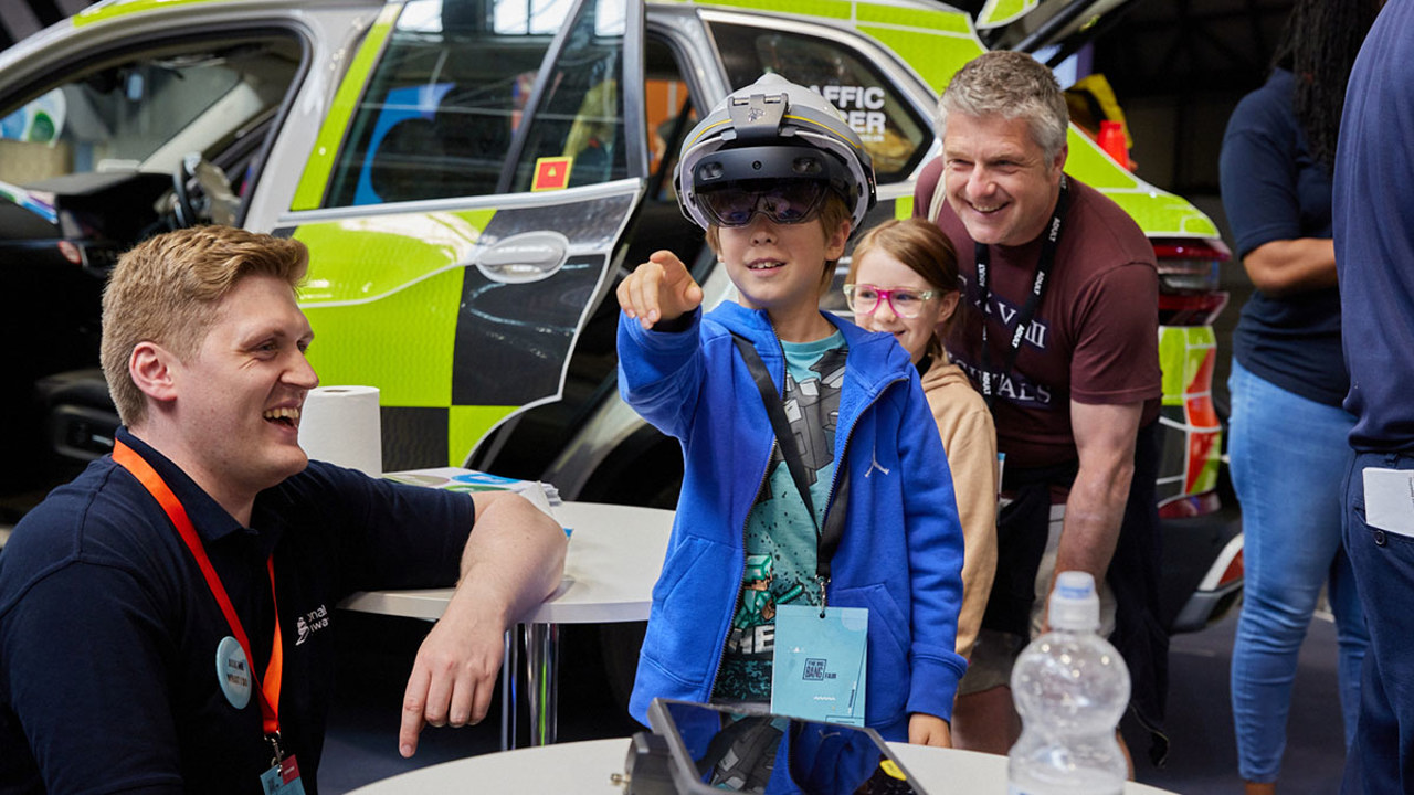 Young people interact with exhibits and stands and activities at The Big Bang Fair