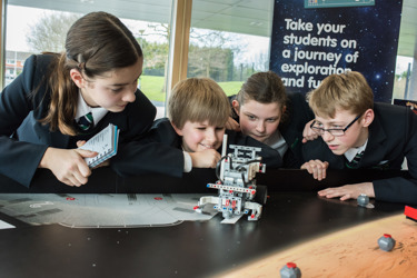 A group of young people build a robot