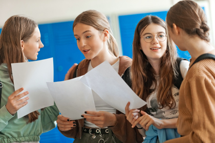A group of young people look at their exam results