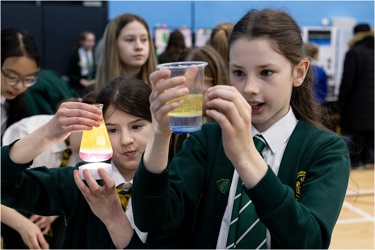 Young people conducting a science experiment in school