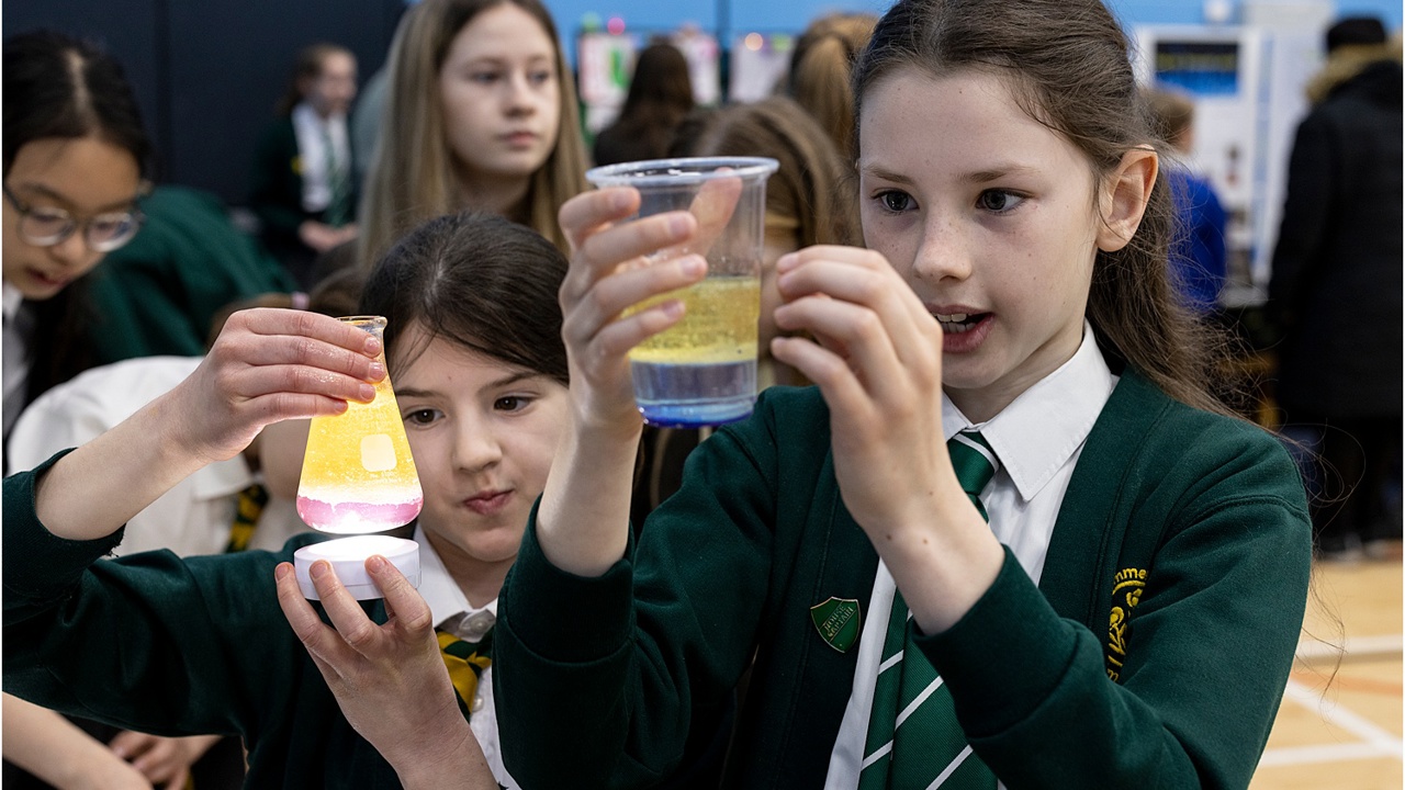 Young people conducting a science experiment in school